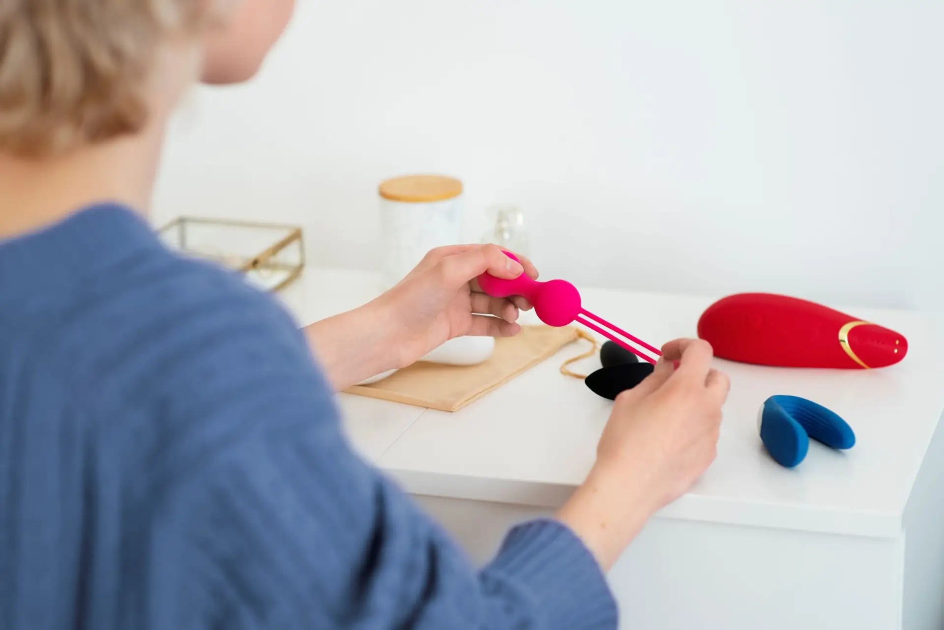 Person using a sexual wellness toy for intimate care and pleasure